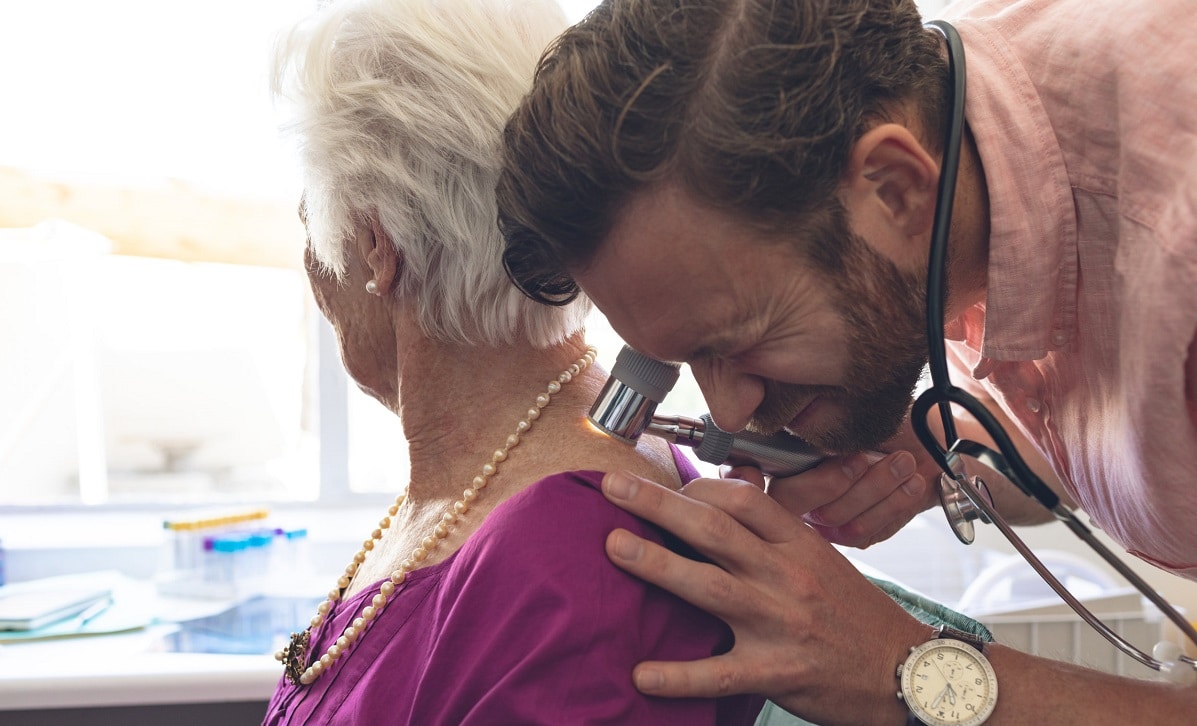 Medical practotioner examining a patient for signs of actinic keratosis